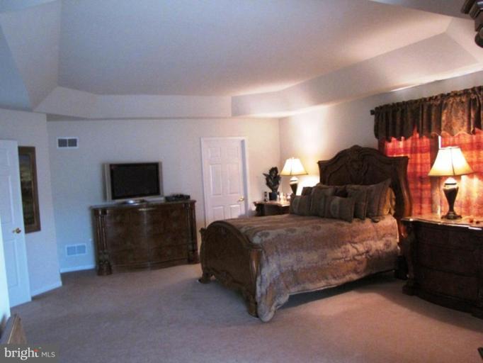 6 Vince Court Elkton, MD 21921 - Photo 17 of 21 a spacious bedroom with a bed and a television in it