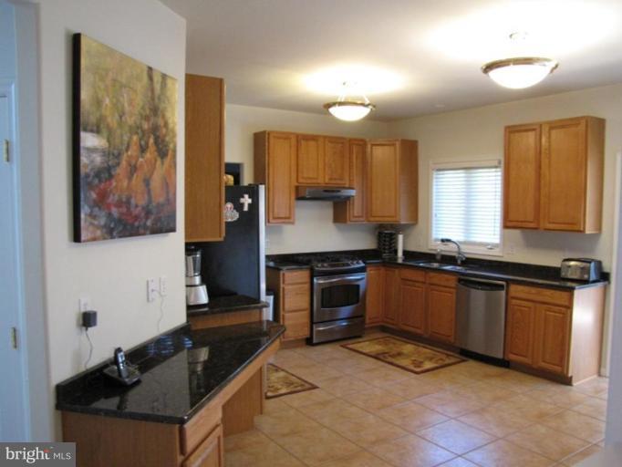 6 Vince Court Elkton, MD 21921 - Photo 4 of 21 a kitchen with stainless steel appliances granite countertop a stove top oven a sink a counter space and cabinets