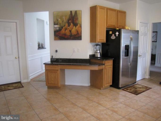6 Vince Court Elkton, MD 21921 - Photo 5 of 21 a kitchen with granite countertop a refrigerator and a stove top oven