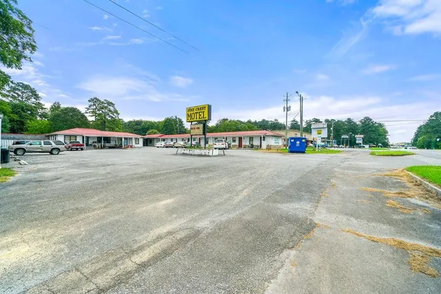 a view of a city street with a building and cars park
