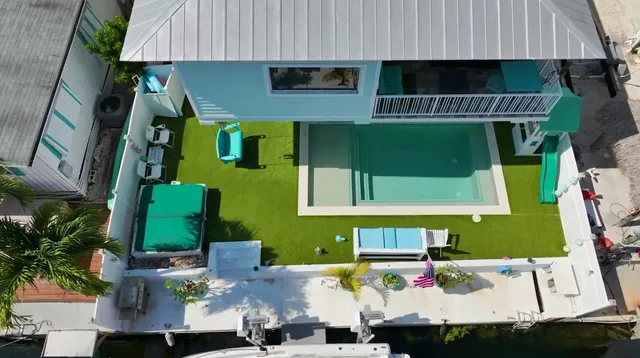 an aerial view of a house with a yard