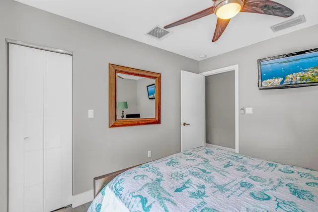 a bedroom with bed and painting on the wall