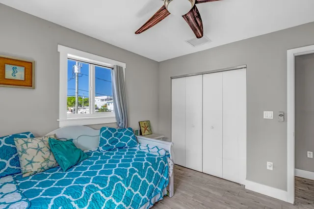 a bedroom with a bed and a window