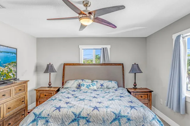 a bedroom with a bed and a lamp on a dresser