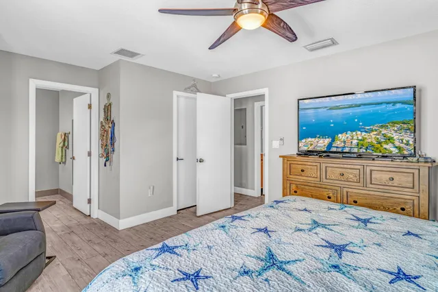 a bedroom with a bed and wooden floor