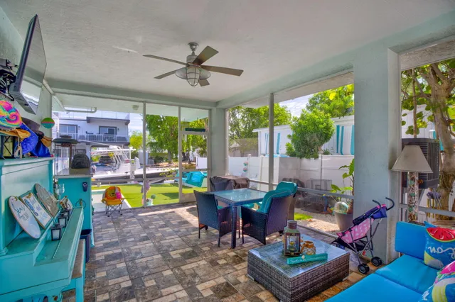 a living room with furniture a fireplace and a floor to ceiling window
