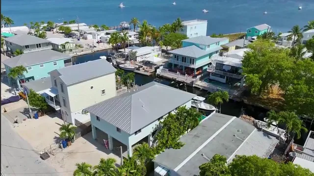 an aerial view of a house with a yard and garden
