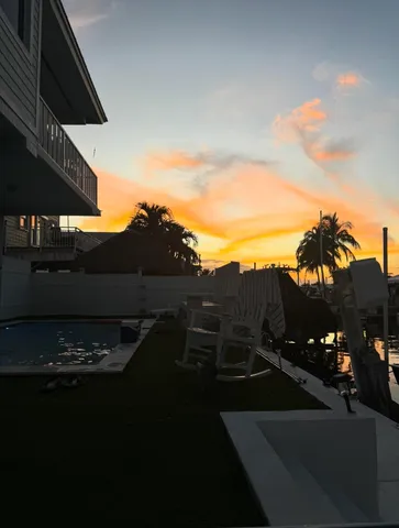 a view of a roof deck with table and chairs under an umbrella