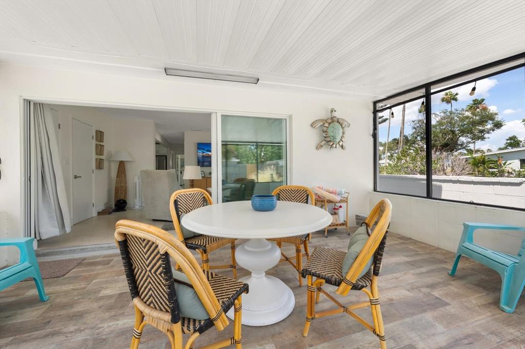 127 11th Avenue Indian Rocks Beach, FL 33785 - Photo 26 of 63 a dining room with furniture a rug and a large window