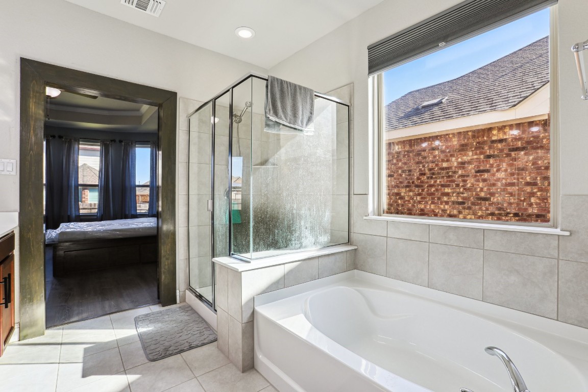 3602 Chaff Lane Pflugerville, TX 78660 - Photo 11 of 28 Bathroom featuring independent shower and bath and tile patterned flooring