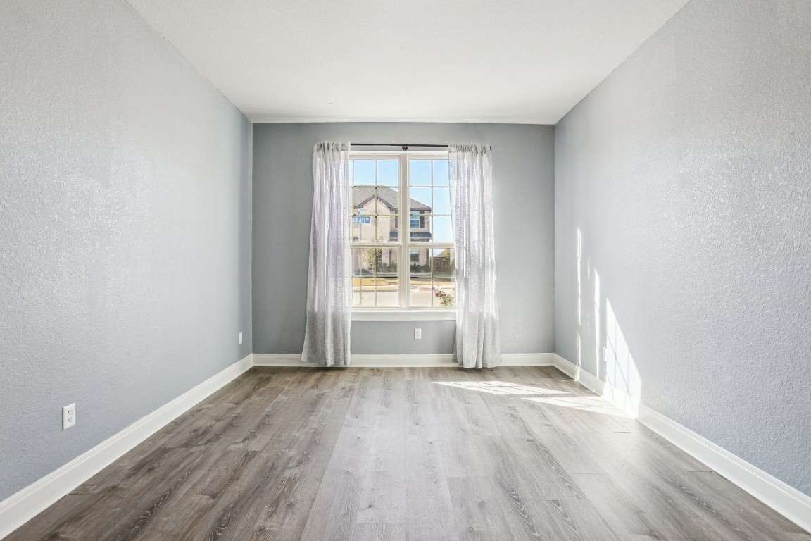 3602 Chaff Lane Pflugerville, TX 78660 - Photo 14 of 28 Empty room with light hardwood / wood-style flooring