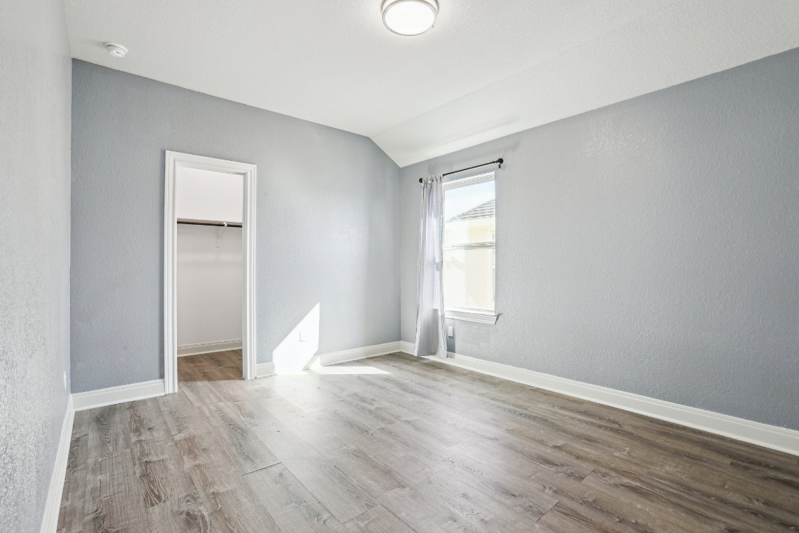 3602 Chaff Lane Pflugerville, TX 78660 - Photo 19 of 28 Unfurnished bedroom with a closet, vaulted ceiling, and a spacious closet