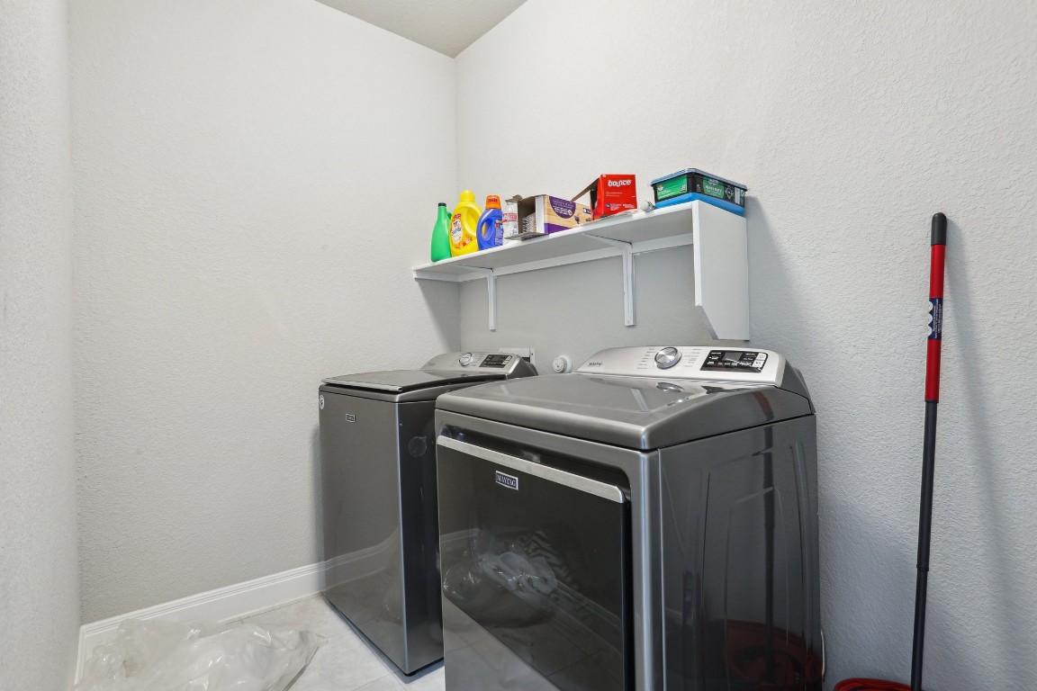 3602 Chaff Lane Pflugerville, TX 78660 - Photo 25 of 28 Laundry room featuring light tile patterned floors and washing machine and dryer