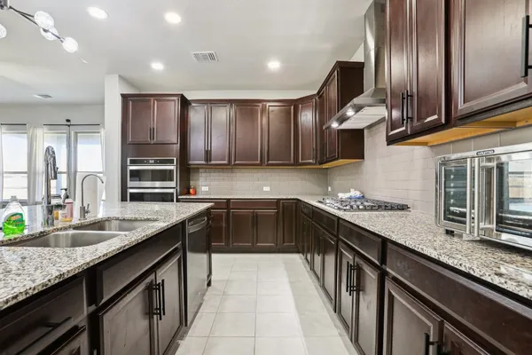 a kitchen with stainless steel appliances granite countertop counter space a sink and cabinets