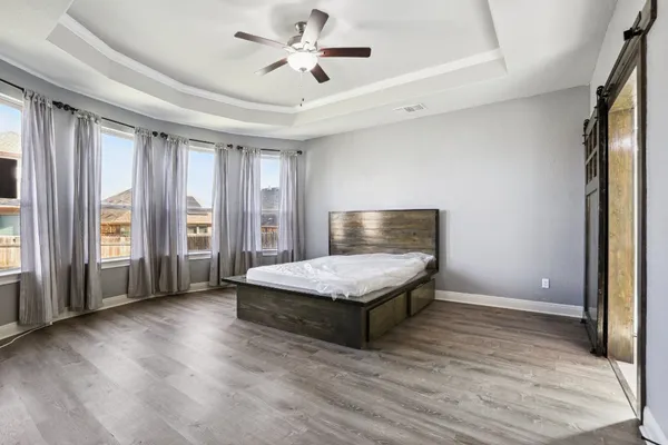 a living room with stainless steel appliances granite countertop furniture wooden floor and a window