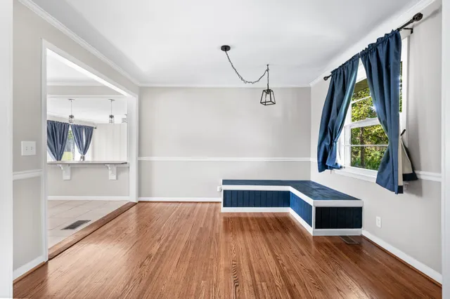 a view of front door with wooden floor and a window
