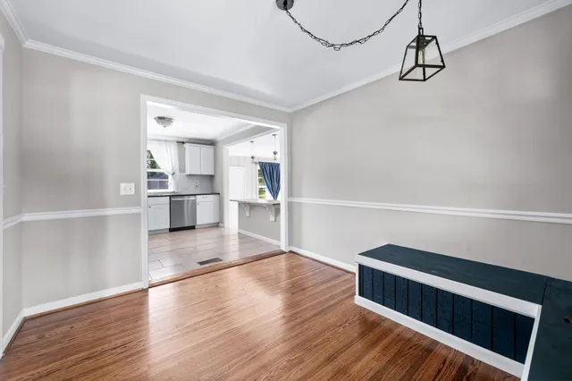 a view of kitchen with wooden floor and electronic appliances