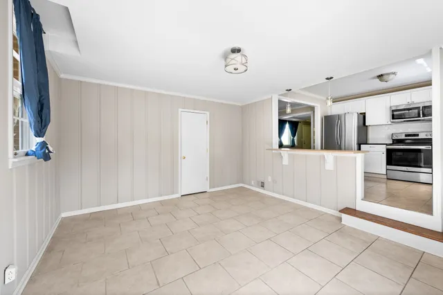 a view of a kitchen with a sink and a refrigerator