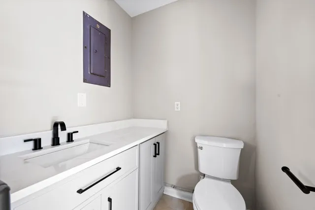a bathroom with a toilet sink and mirror