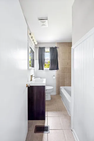 a bathroom with a sink a toilet and tub