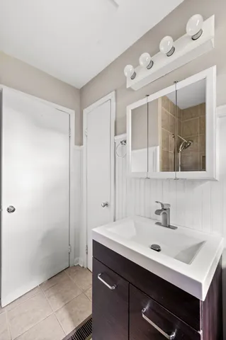 a bathroom with a sink mirror and vanity