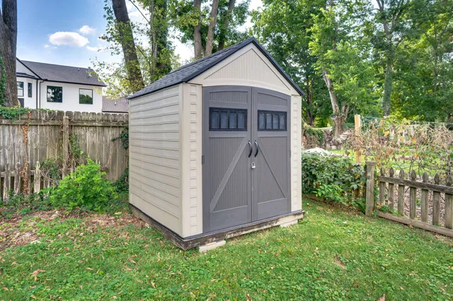 a view of backyard of house with green space