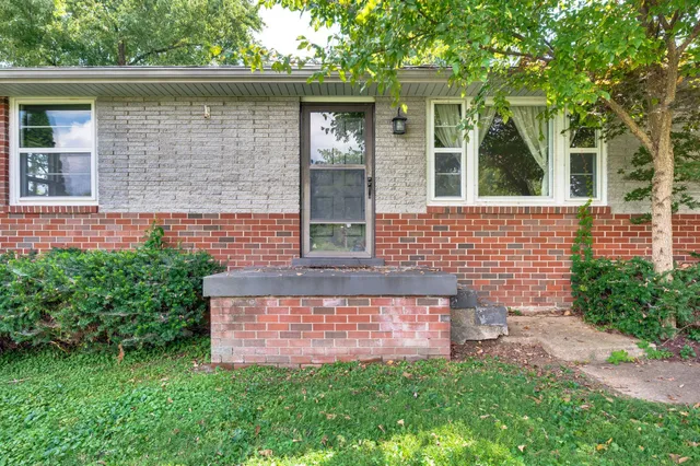 a brick house with a large windows