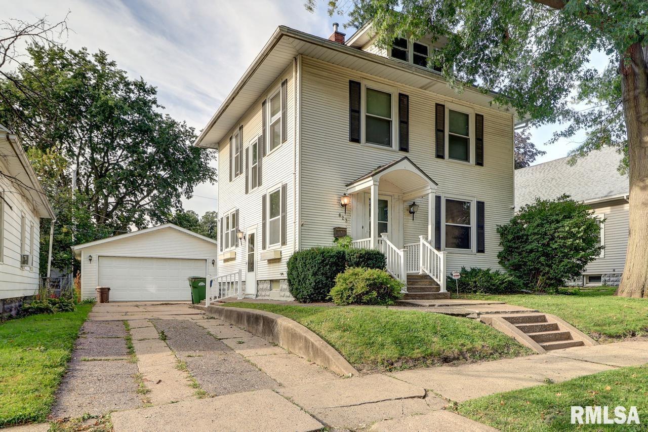 823 14th Avenue South Clinton, IA 52732 - Photo 2 of 27 a front view of a house with a yard and a garage