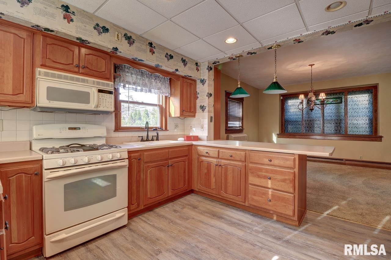 823 14th Avenue South Clinton, IA 52732 - Photo 5 of 27 a kitchen with stainless steel appliances granite countertop a stove a sink and a microwave