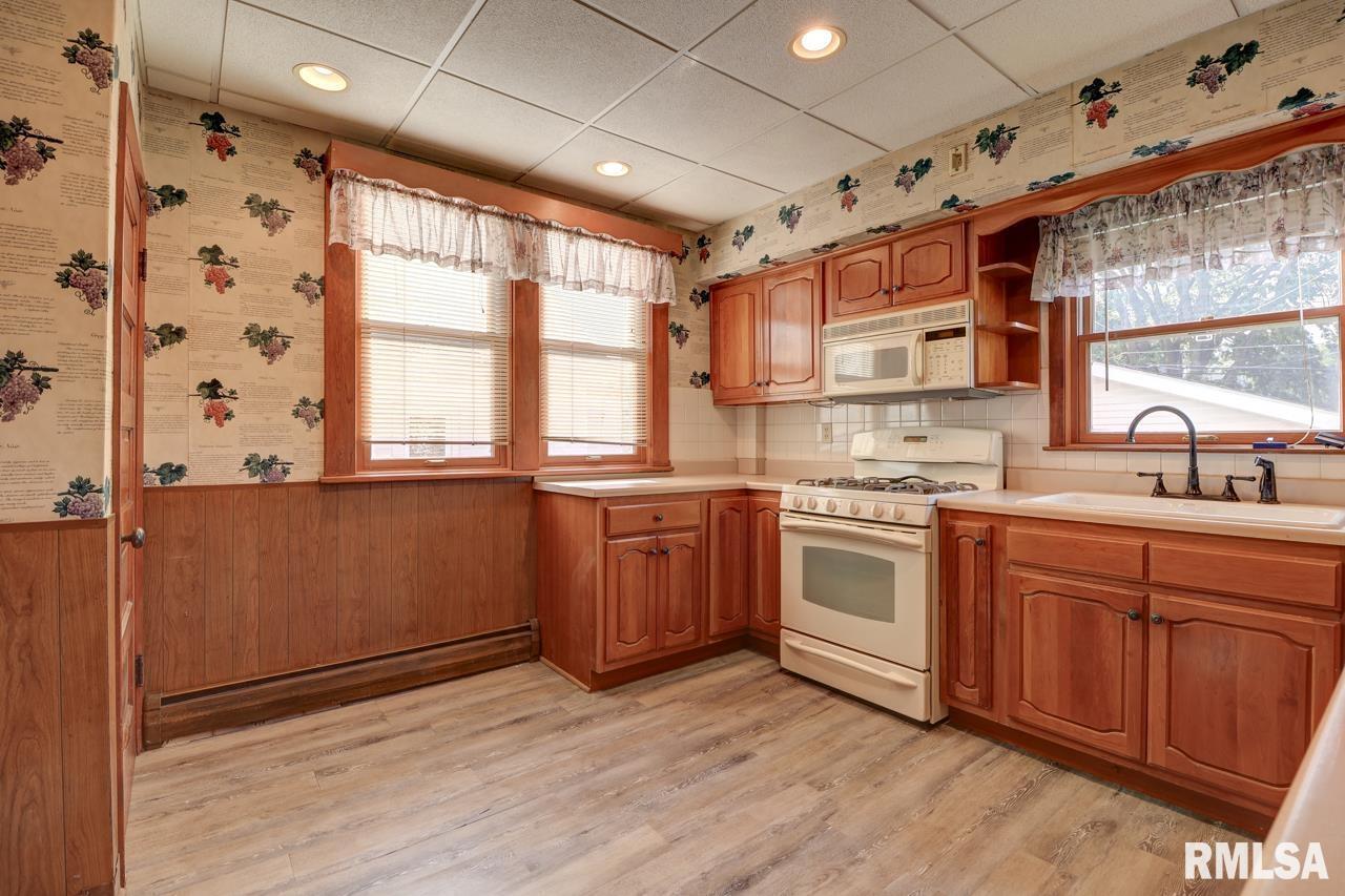 823 14th Avenue South Clinton, IA 52732 - Photo 7 of 27 a kitchen with stainless steel appliances granite countertop a stove and a sink