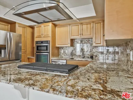 a view of a kitchen with a sink and cabinets