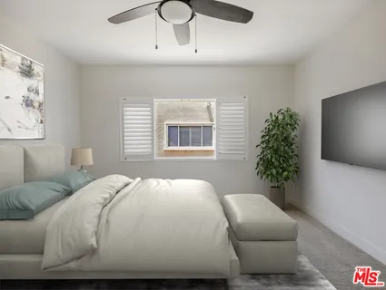 a bedroom with a large bed and a potted plant