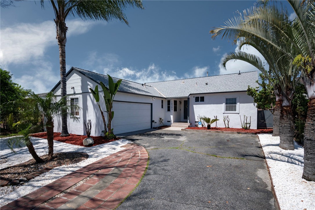 a view of a house with backyard and sitting area