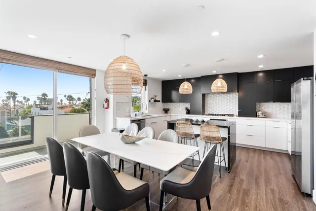 a large kitchen with a table and chairs