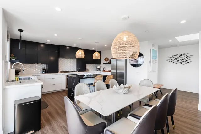 a kitchen with stainless steel appliances granite countertop a stove a sink and a refrigerator