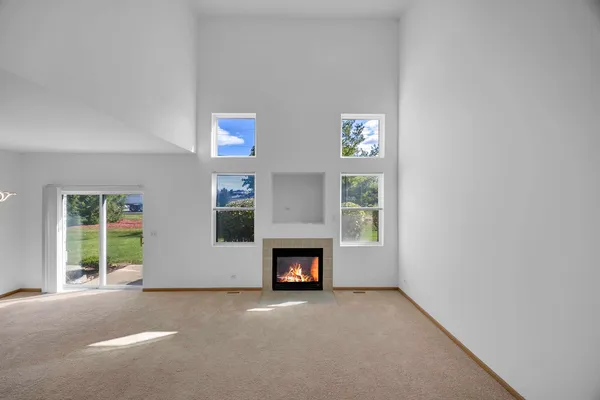 a view of a livingroom with a fireplace and window