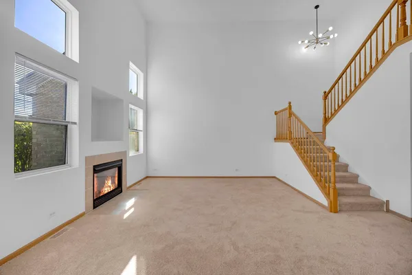 a view of an empty room with staircase