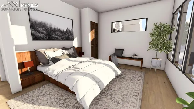 a bed sitting in a bedroom next to a window