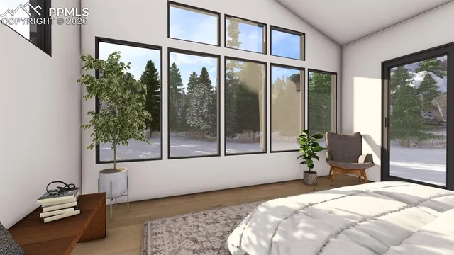 a bedroom with a bed and a large window with outer view