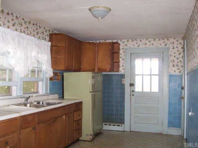 132 Harris Street Roxboro, NC 27573 - Photo 3 of 4 a kitchen with a refrigerator and a sink