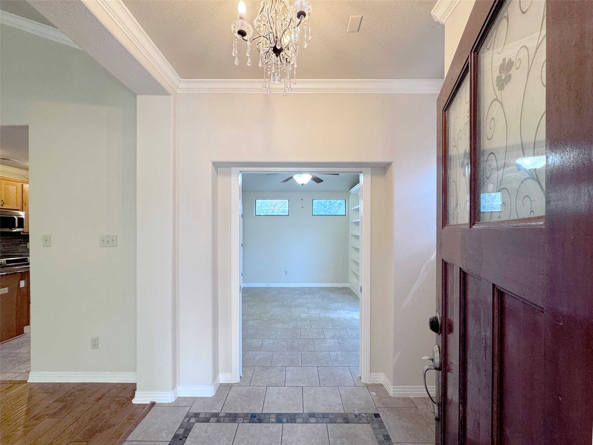 9707 Anderson Mill Road, Unit 21 Austin, TX 78750 - Photo 5 of 27 An elegant entryway welcomes guests with custom tile detailing and a classic overhead fixture.