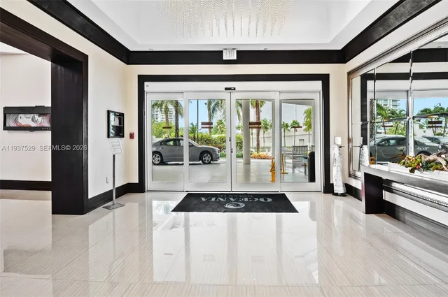a living room with stainless steel appliances granite countertop furniture and a large window