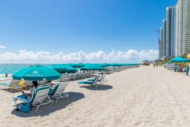 swimming pool view with a seating space
