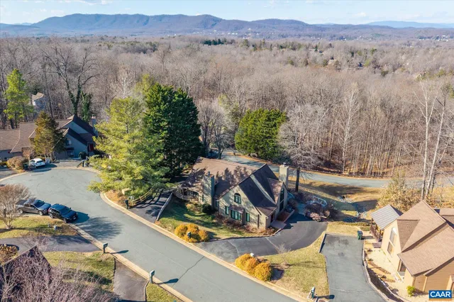 an aerial view of a house with a yard and lake view