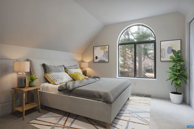 a living room with furniture and potted plant