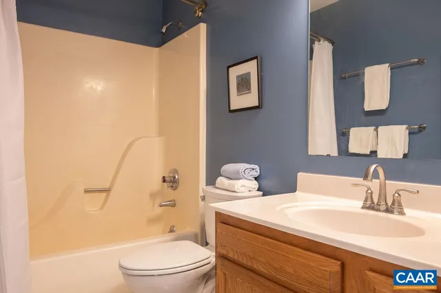 a bathroom with a sink a toilet and shower curtain