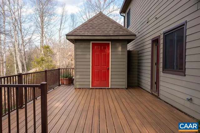 a view of a wooden door with wooden floor and fence