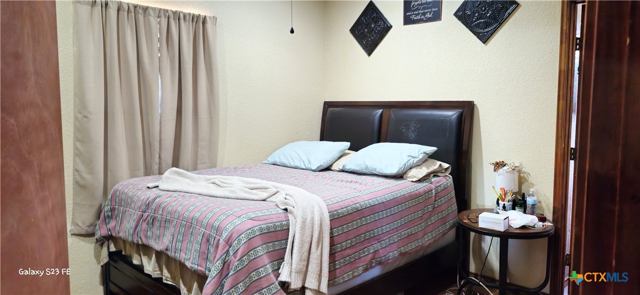 414 Harl Street Pleasanton, TX 78064 - Photo 14 of 28 a bedroom with a bed and cabinets
