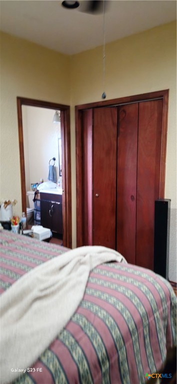 414 Harl Street Pleasanton, TX 78064 - Photo 16 of 28 a bedroom with a bed and a dresser