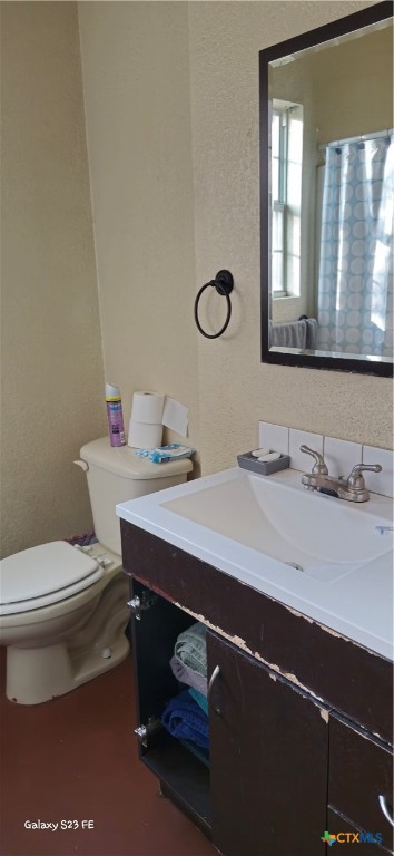 414 Harl Street Pleasanton, TX 78064 - Photo 20 of 28 a bathroom with a sink a toilet and mirror